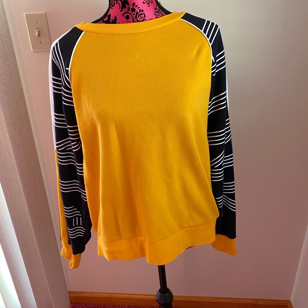 a yellow PINK crewneck